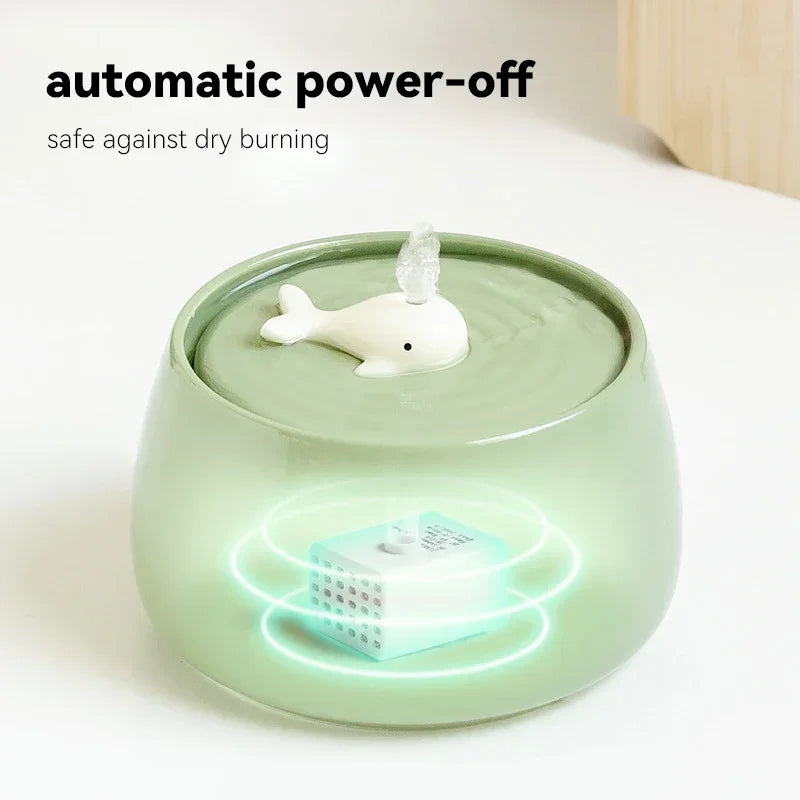 Humidificateur design en verre vert avec une fontaine en forme de dauphin et arrêt automatique.